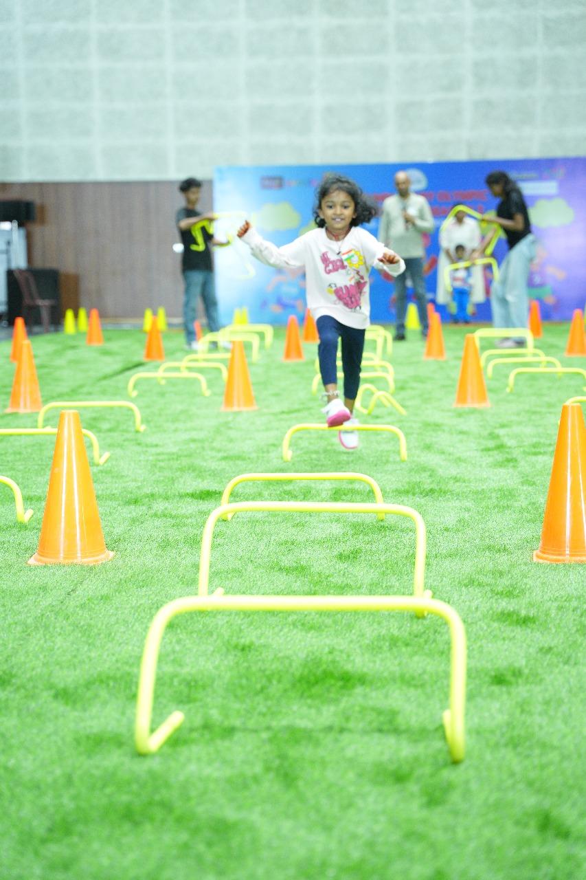 A child enjoying a hurdle activity at NIBOG